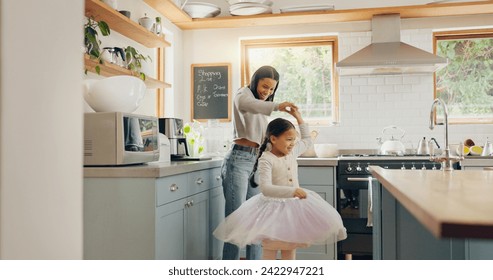 Dance, ballet and girl with mother in a kitchen together or mom support child and playing as a dancer or ballerina. Tutu skirt, mommy and woman dancing, bonding or spin with kid in house or home - Powered by Shutterstock