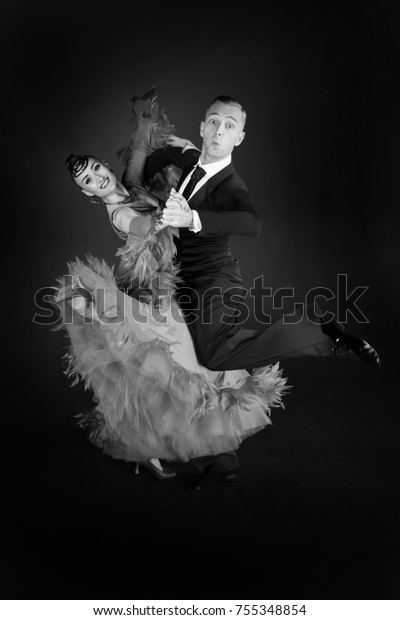 dance ballroom couple in dress\
dance pose isolated on black background. sensual professional\
dancers dancing walz, tango, slowfox and quickstep. black and\
white