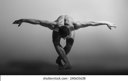 Dance freedom concept. Young handsome ballet man in grace pose. Perfect hair & skin. Close up. Studio shot