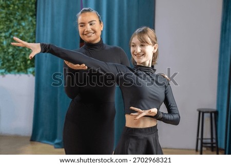 Dance instructor showing student dancing moves