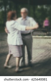Dance older person: retro photo background. Old people- active dancing couple in the park.