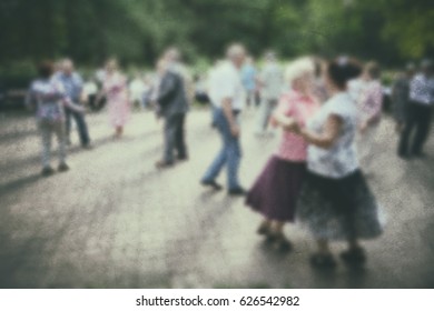 Dance older person: retro photo background. Old people- active dancing couple in the park.