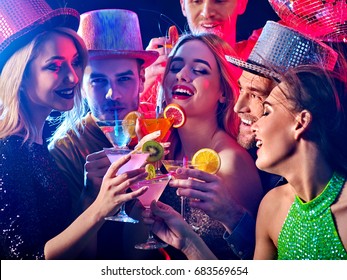 Dance Party With Group People Dancing. Women And Men Have Fun And Drinking Martini Cocktail In Night Club. Happy Girl On Foreground And Disco Ball On Background. Rest After A Hard Day At Work.