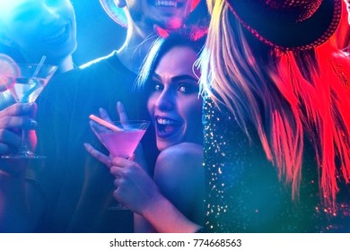 Dance party with group people dancing. How to pick up girls at a club. Women and men have fun in night club. Seduce woman cuddles up guy . Opening of a new strip club.