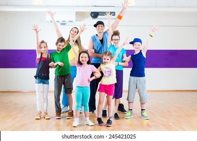 Dance Teacher Giving Children Zumba Fitness Class In Gym