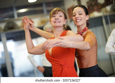 Dance Teacher Showing Senior Woman Correct Gesture