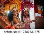 Dancer, confetti and carnival for party, event or street festival as parade or entertainment in Brazil. Female people, fashion and celebration for art, show or culture as tradition in Rio de janeiro