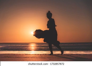 Dancer On The Beach In The Golden Sunlight. Mindil Beach, Darwin, NT, Australia.