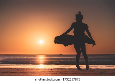 Dancer On The Beach In The Golden Sunlight. Mindil Beach, Darwin, NT, Australia.