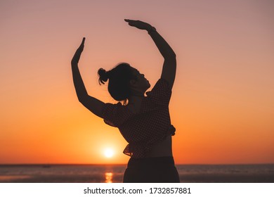 Dancer On The Beach In The Golden Sunlight. Mindil Beach, Darwin, NT, Australia.