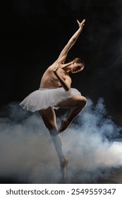 Dancer performing an elegant ballet pose amidst dramatic smoke effects