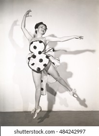 Dancer In Polka Dot Costume Leaping In Mid Air