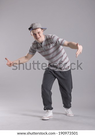 Similar – A teenage boy stretches down, pulling his head to his knees, outdoors