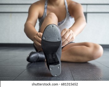 Dancer Putting on her Tap Shoes