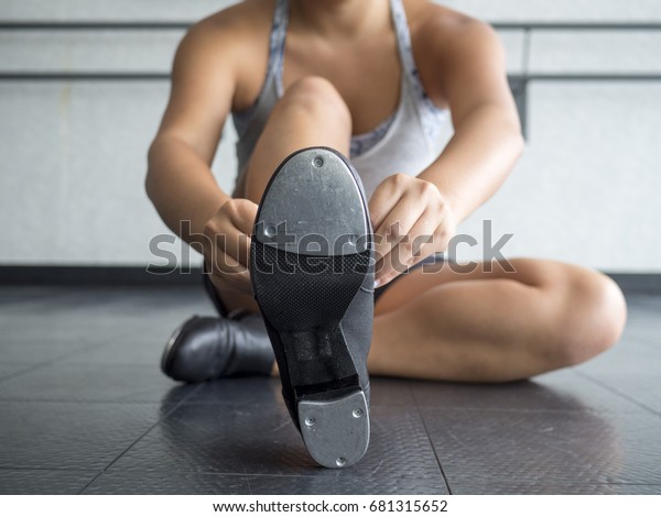 Dancer Putting on her Tap\
Shoes