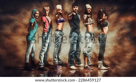 Dancer team on dramatic background with explosion