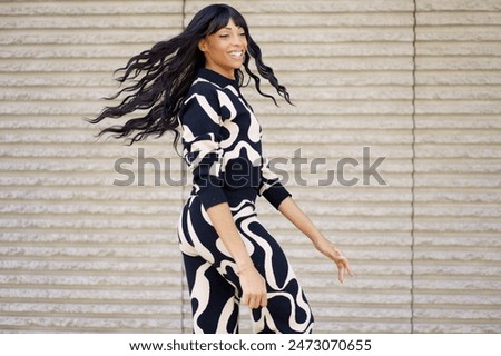 Similar – Dancer turning energetically and smiling at camera in the city