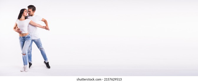 Dancers couple dancing social latin dance bachata kizomba salsa - social dance. Two elegance pose on white background with copy space and place for advertising
