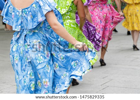 Dancers dancing and wearing one of the traditional folk costume from Puerto Rico
