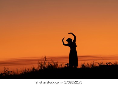 Dancer's Silhouette Against The Golden Sky. Mindil Beach, Darwin, NT, Australia.