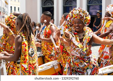 Dancer's small parade with traditional costumes celebrating with revelers the Carnival on the streets. Salvadore, Bahia, Brazil, 02/11/2019