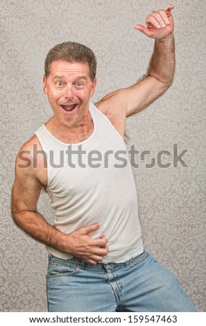 Dancing Caucasian man in blue jeans and undershirt