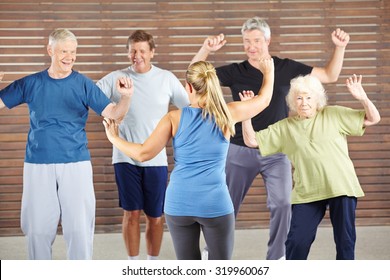 Dancing class with happy senior people in a gym