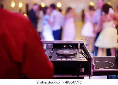 Dancing couples during party or wedding celebration by dj mixer and space for text