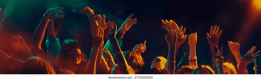 Dancing crowd silhouettes under dramatic concert lighting. Concept of shared emotions, rhythmic movement, social connection, music immersion and Christmas night celebration atmosphere. Banner