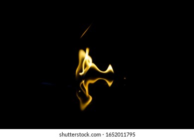 dancing flashes of flame with reflection on a black background