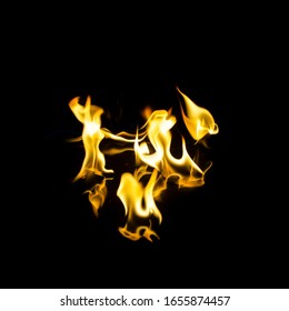 dancing flashes of flame with reflection on a black background