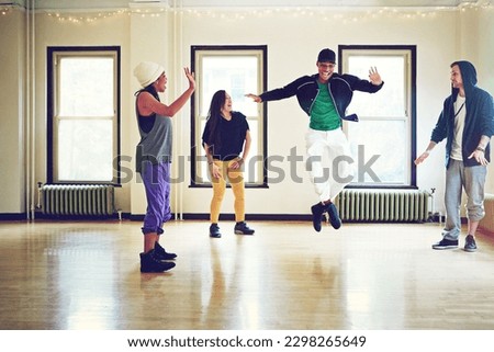 Dancing is a full body experience. a group of young friends dancing together in a studio.