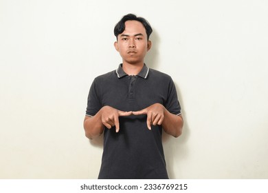 dancing gesture viral on social media Indonesian man wearing black shirt on isolated white background. disc jokey gesture. Asians dancing to "If We Ever Broke Up" - Shutterstock ID 2336769215