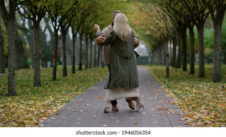 Dancing Happy Elderly Couple Having Fun With Pleasure In Autumn Park. Romantic Family Dancing In Love Outdoors. Beautiful Blonde Woman Jumping For Joy In Man Huggs Outdoor.