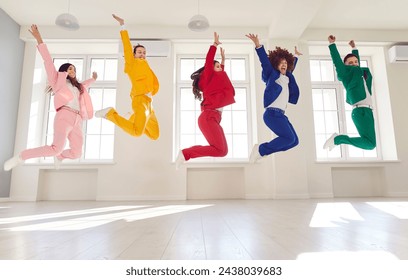 Dancing high jump group people, cool happy dance entertainment, office party gathering, bright formal suit. Young cute disco team, color suit set wear, express enjoyment, event celebration performance - Powered by Shutterstock