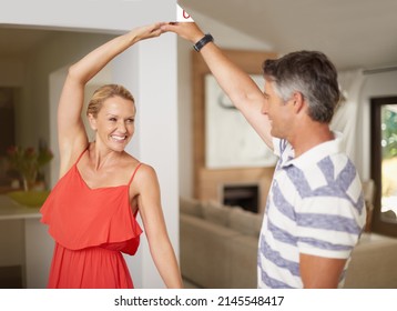 Dancing Is Like Dreaming With Your Feet. Shot Of A Happily Married Couple Dancing Together At Home.