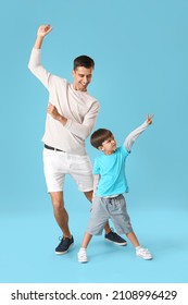 Dancing man and his little son on color background - Shutterstock ID 2108996429