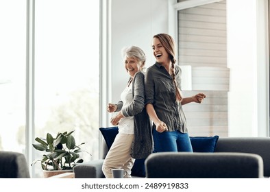 Dancing, mature woman and daughter with celebration in house, movement and time together. Family, girl and mama with energy, parent and hobby with wellness, healthy and stress relief in living room - Powered by Shutterstock