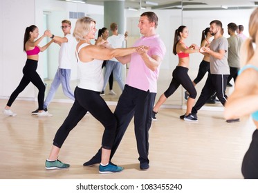 Dancing Positive Spanish  Couples Learning Salsa At Dance Class