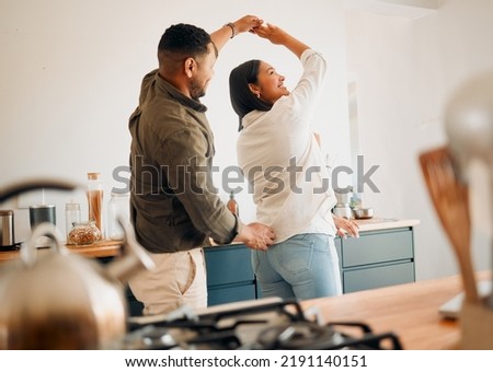 Dancing, romance and playful couple having fun, love and bonding while laughing, spinning and twirling together at home. Loving husband enjoying care, affection and joy while relaxing with happy