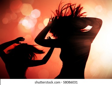 dancing silhouettes of woman in a nightclub