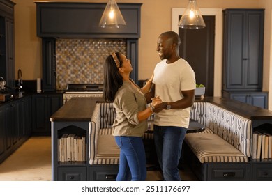 Dancing together, multiracial couple enjoying quality time in modern kitchen at home. Lifestyle, relationship, happiness, togetherness - Powered by Shutterstock