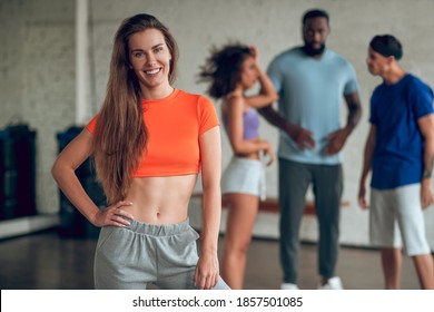 Dancing together. A smiling woman having a dance rehearsal with her colleagues - Powered by Shutterstock