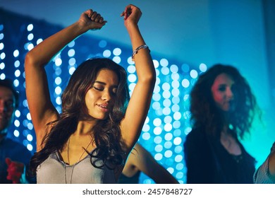 Dancing, woman and confidence in nightclub for birthday, new year and party or disco in Mexico. Smile, enjoyment and eyes closed in festival for concert, music and celebration on dance floor in city - Powered by Shutterstock