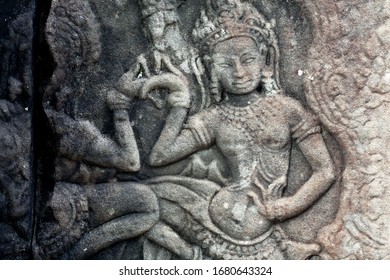 Dancing Woman On 12th Century Ruined Relief Of The Bayon Temple, Cambodia. Historical Artwork On Column Of Khmer Landmark In Angkor. UNESCO World Heritage Site.