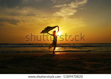 Dancing woman on the beach in Florida.sunset on the beach of Florida