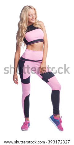dancing young woman in pink sport suit isolated on white