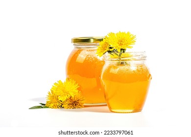 Dandelion jam or honey in the glass jar with fresh dandelion flowers isolated on white background. Seasonal product, trendy hard light, dark shadow, copy space - Shutterstock ID 2233797061