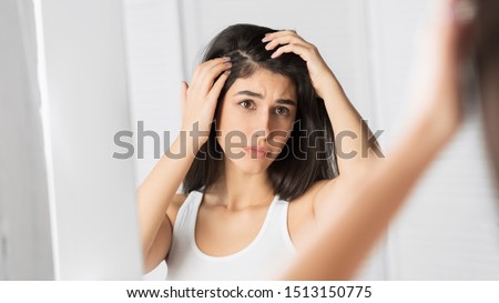Dandruff Problem. Brunette Girl Looking At Hair Flakes In Mirror Standing In Bathroom. Panorama, Selective Focus Foto stock © 