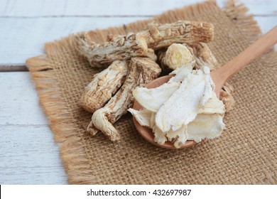 dang gui (angelica sinensis) and dang gui ginseng slice on wooden spoon, traditional chinese herbal medicine.